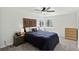 A well-lit main bedroom features a decorative headboard, ceiling fan, and neutral-colored walls at 12143 Dahlia Dr, Thornton, CO 80241