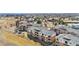 An aerial view showcases this brick apartment complex with well-maintained landscaping and ample parking at 8944 Fox Dr, Denver, CO 80260