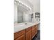 Bathroom featuring a long counter with vanity, white counters and dark floors at 8944 Fox Dr, Denver, CO 80260