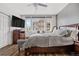 Comfortable bedroom with natural light, wood flooring, and a serene color palette at 8944 Fox Dr, Denver, CO 80260