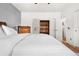 Bright bedroom with built-in shelving and neutral decor with a view out the windows at 8944 Fox Dr, Denver, CO 80260