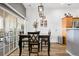 Well-lit dining area with hardwood floors and sliding glass doors at 8944 Fox Dr, Denver, CO 80260