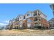 Multi-story brick building with balconies and well-maintained landscaping at 8944 Fox Dr, Denver, CO 80260