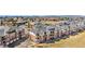 Attractive townhome exteriors featuring a combination of brick and siding, complemented by neatly kept lawns at 8944 Fox Dr, Denver, CO 80260
