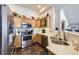 Well-equipped kitchen with stainless steel appliances, quartz countertops and wood cabinets at 8944 Fox Dr, Denver, CO 80260