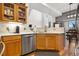 Lovely kitchen featuring stainless steel dishwasher and hardwood floors at 8944 Fox Dr, Denver, CO 80260