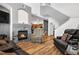 Inviting living room featuring a cozy fireplace, hardwood floors and plush seating at 8944 Fox Dr, Denver, CO 80260