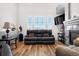 Comfortable living area with fireplace, large windows, and hardwood flooring at 8944 Fox Dr, Denver, CO 80260