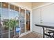 Cozy patio featuring sliding glass doors, wooden deck, and a small table with seating at 8944 Fox Dr, Denver, CO 80260
