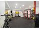 Well-equipped home gym with rubber flooring, mirrors, and a variety of exercise machines and weights at 16034 Columbine St, Thornton, CO 80602