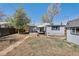 The backyard features patio dining, grill, and a well-maintained lawn at 3768 S Acoma St, Englewood, CO 80110
