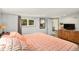 Bright bedroom with a window and a wood dresser at 3768 S Acoma St, Englewood, CO 80110