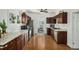 Traditional kitchen featuring wood cabinets, granite countertops, and stainless steel appliances at 3768 S Acoma St, Englewood, CO 80110