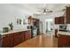 Efficient kitchen with wood cabinetry, modern appliances, and view of additional living space at 3768 S Acoma St, Englewood, CO 80110