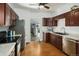 Traditional kitchen featuring wood cabinets, granite countertops, and stainless steel appliances at 3768 S Acoma St, Englewood, CO 80110