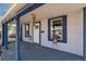 Inviting covered porch with detailed trim, potted plants, and wind chimes creates a relaxing outdoor space at 3768 S Acoma St, Englewood, CO 80110