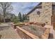 Backyard with a patio, raised garden beds and a privacy fence at 6922 W Walden Pl, Littleton, CO 80128