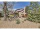 Landscaped backyard with tall trees, bushes and a privacy fence at 6922 W Walden Pl, Littleton, CO 80128