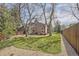 The spacious, grassy backyard is fenced and lined with mature trees, providing privacy at 6922 W Walden Pl, Littleton, CO 80128