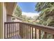 A balcony with a wood railing overlooks the front yard at 6922 W Walden Pl, Littleton, CO 80128