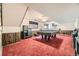 The finished basement offers a billiards table, wood paneling and recreation space at 6922 W Walden Pl, Littleton, CO 80128
