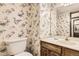 Half bath with floral wallpaper and a pedestal sink at 6922 W Walden Pl, Littleton, CO 80128