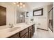 Large bathroom features a double vanity, marble countertops, and separate shower at 6922 W Walden Pl, Littleton, CO 80128