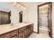 Double vanity sink with wood cabinets and separate shower room offers a modern touch at 6922 W Walden Pl, Littleton, CO 80128