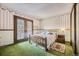Bright bedroom with french doors and floral wallpaper creates a cottage-like feel at 6922 W Walden Pl, Littleton, CO 80128