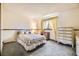 Charming bedroom with floral wallpaper, decorative wainscoting and vintage furniture at 6922 W Walden Pl, Littleton, CO 80128