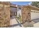Close-up of the entrance features stone pillars, a pergola, manicured landscaping and inviting walkway at 6922 W Walden Pl, Littleton, CO 80128