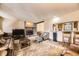 Spacious living room with stone fireplace and bar seating at 6922 W Walden Pl, Littleton, CO 80128