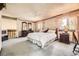 Spacious main bedroom with decorative wallpaper and an adjoining room at 6922 W Walden Pl, Littleton, CO 80128