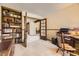 Inviting office with built-in bookshelves and a view into dining area at 6922 W Walden Pl, Littleton, CO 80128