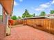 Private brick patio with wood fence, perfect for outdoor entertaining and relaxing at 12664 W Virginia Ave, Lakewood, CO 80228