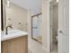 Updated bathroom featuring vanity with double sinks and walk-in shower with glass doors at 12664 W Virginia Ave, Lakewood, CO 80228