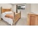 Bedroom featuring a bed and dresser, with view of the home's exterior at 12664 W Virginia Ave, Lakewood, CO 80228