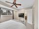 Bright bedroom featuring neutral walls, plush carpet, ceiling fan and adjacent bathroom at 12664 W Virginia Ave, Lakewood, CO 80228
