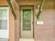 Close-up of front door and mailbox, featuring brick facade, green accents, and house number at 12664 W Virginia Ave, Lakewood, CO 80228