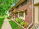 Charming two-story brick townhouse with green lawn and front garden at 12664 W Virginia Ave, Lakewood, CO 80228