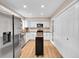 Well-lit kitchen features stainless steel appliances, white cabinets, and a mobile island for extra counter space at 12664 W Virginia Ave, Lakewood, CO 80228