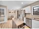 Open kitchen area with a dining area, stainless steel appliances, and granite counters at 12664 W Virginia Ave, Lakewood, CO 80228