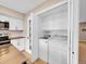 Convenient laundry area features a washer, dryer, and storage within a closet at 12664 W Virginia Ave, Lakewood, CO 80228