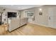 Spacious living room with large television, window with natural light, and open floorplan at 12664 W Virginia Ave, Lakewood, CO 80228