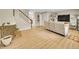 Bright living room boasts hardwood floors, a brick fireplace, and staircase to the upper level at 12664 W Virginia Ave, Lakewood, CO 80228