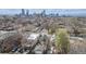 A high-angle view showcases a neighborhood with single-Gathering homes, garages, and greenery against a city skyline backdrop at 2224 N Humboldt St, Denver, CO 80205