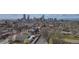 A stunning aerial shot of a neighborhood with buildings and streets beneath a bright sky and city skyline in the background at 2224 N Humboldt St, Denver, CO 80205