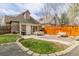 Spacious backyard with a lush lawn, patio dining area, and a charming fence; ideal for relaxation and entertainment at 2224 N Humboldt St, Denver, CO 80205