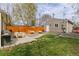 Well-maintained backyard with a patio dining area, a grill, a bench, and a lush lawn surrounded by a privacy fence at 2224 N Humboldt St, Denver, CO 80205