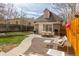 Landscaped backyard with dining & lounge areas, a grill and a stone border, perfect for outdoor living and entertaining at 2224 N Humboldt St, Denver, CO 80205